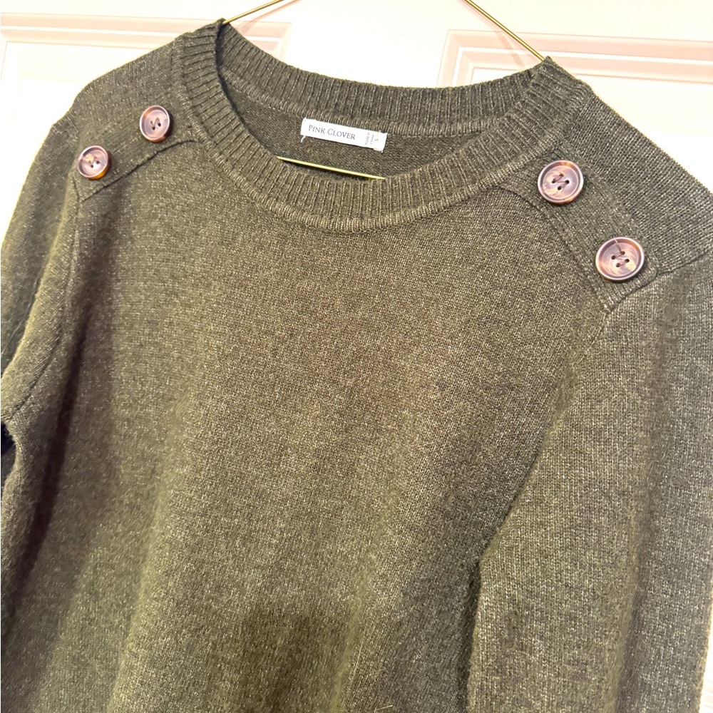 Slim fit olive crewneck sweater with button accessory on each shoulder.